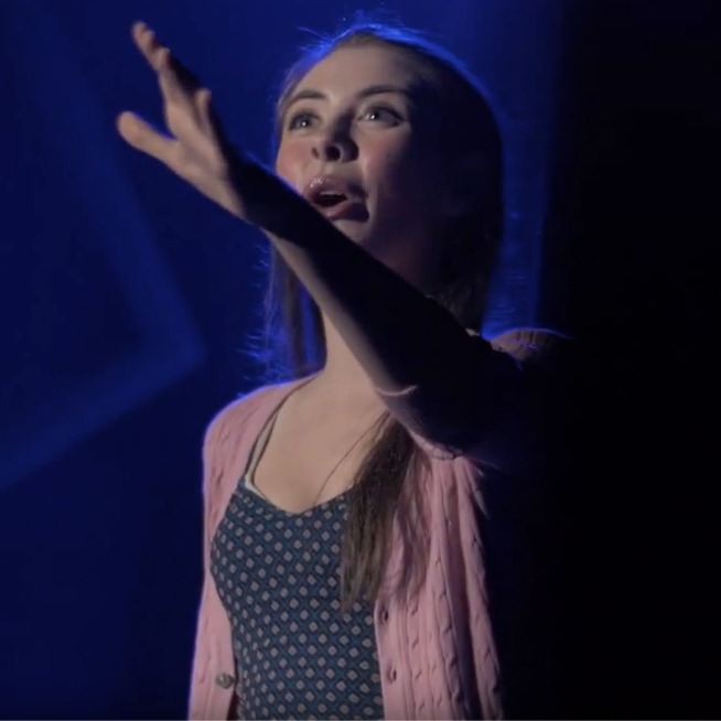 close up of female student acting on stage